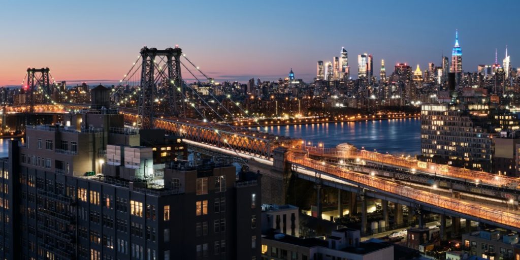 View of the Brooklyn Bridge with the Manhattan skyline in the background.