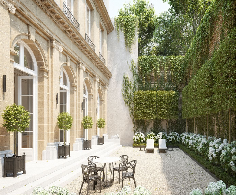 A garden outside the townhouse with flowers and open windows.