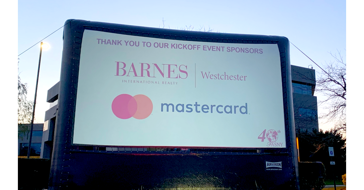 BARNES Westchester logo appears on a big outdoor screen at teh FASNY drive-in movie night.