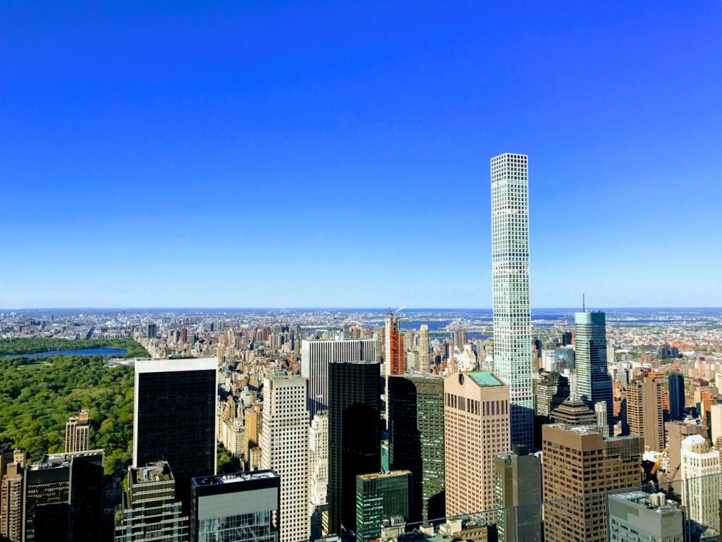 View of the Upper East Side from above, with part of Central park showing on the left, and the NYC northern skyline.